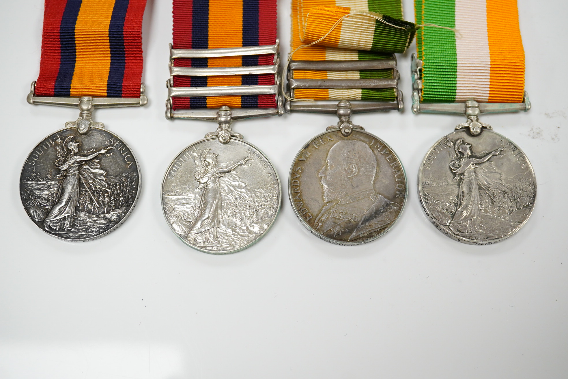 A Queen's South Africa Medal with Laings Nek, Belfast and OFS clasps to 12036 Bomr M.Miller R.F.A.Arty, another unnamed with 1901, 1902 and CC clasps, and two King's South Africa medals both with 1901/1902 clasps to 6408